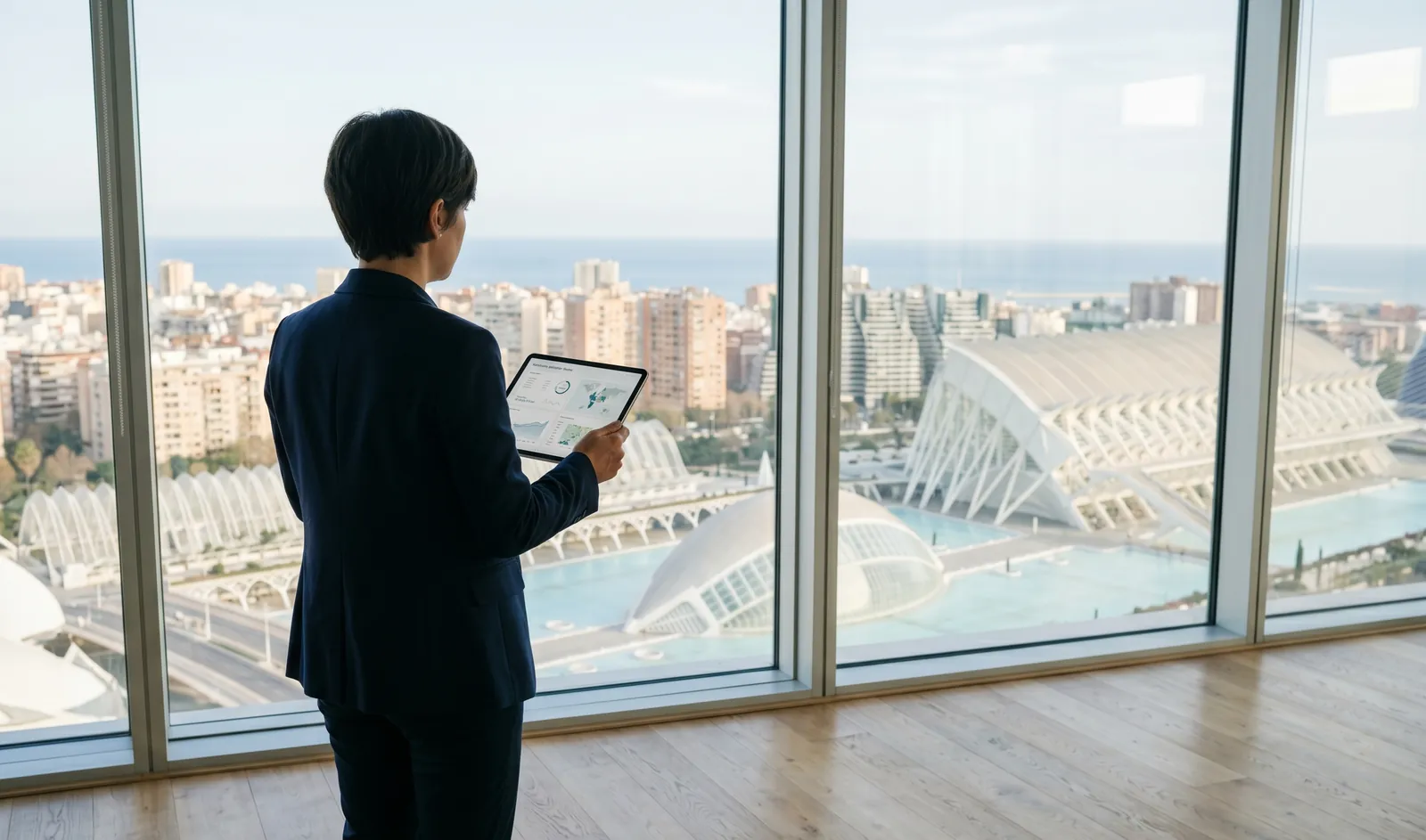 A forward-thinking investor reviewing the Valencia property market from a high-floor office